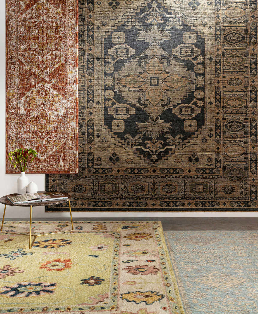 Styled room scene with Strathbogie Traditional Red Area Rug, other rugs, and a modern gold side table with flowers. Styleshot