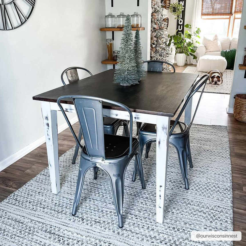 Farmhouse dining room with a black table and the cream and black Williford Wool Area Rug. Roomscene-Rectangle