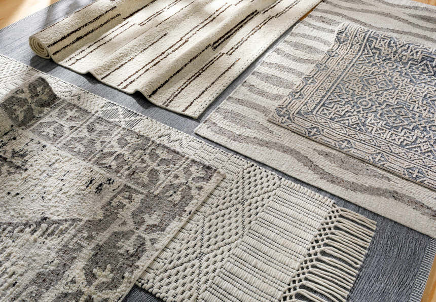 Close-up of Limoges Area Carpet Clearance rugs in black, cream, and gray with geometric, striped, and woven textures. Styleshot