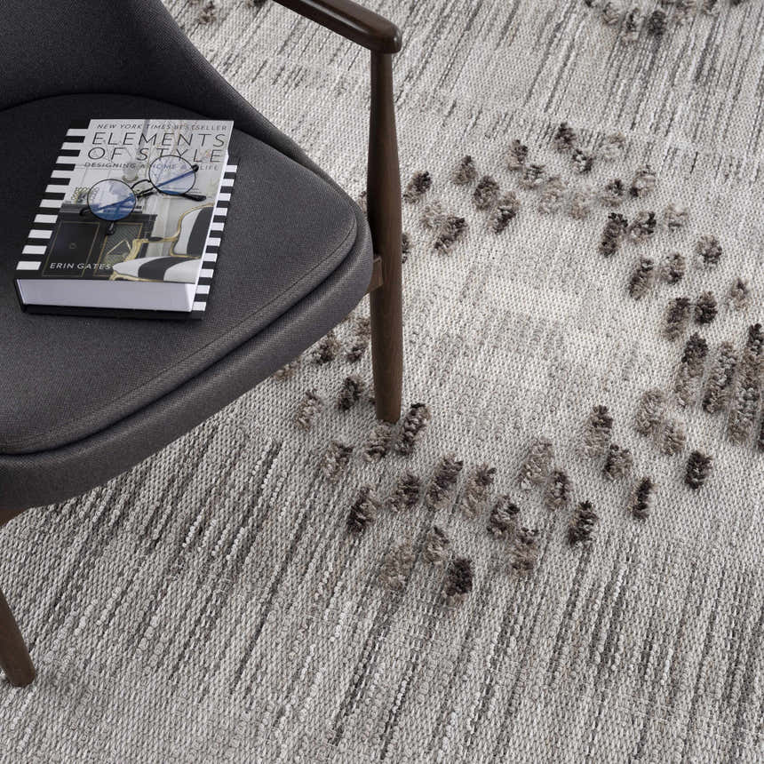 Close-up of the Cabarroguis Area Rug in cream and gray, featuring a geometric pattern and a soft, textured surface. Styleshot