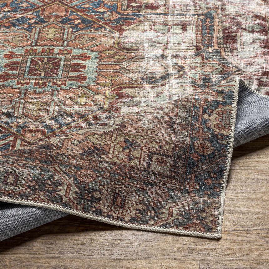 Close-up of the Adtugan Vintage Flat Pile Washable Rug showing its burgundy, navy, and green traditional pattern and low pile. Fold