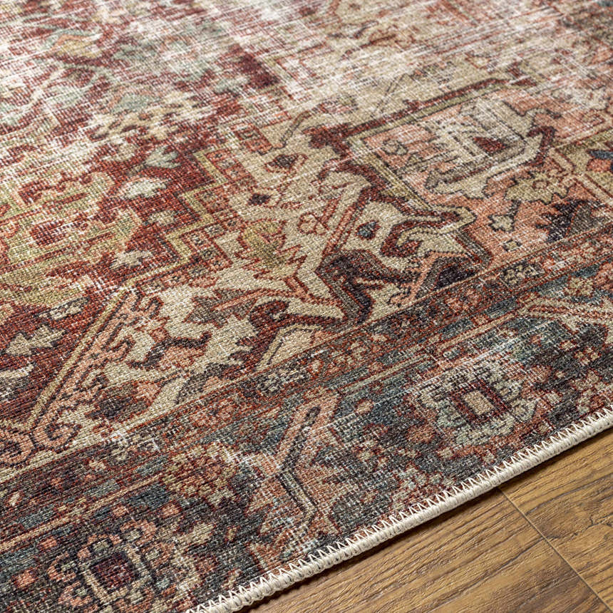Close-up of the Adtugan Vintage Flat Pile Washable Rug. Features a traditional pattern in burgundy, gray, green, and brown tones. Texture