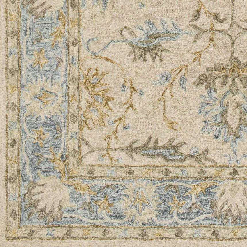 Close-up of the hand-tufted Albert Luxury Wool Rug. Beige rug with charcoal, ice blue, and wheat floral and border pattern. Swatch