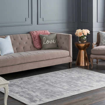 Gray living room with Alcester Gray Premium Sheen Carpet, tufted sofa, and gold accent table. Roomscene-Rectangle