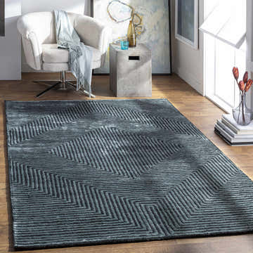 Living room scene with a Quartz Patterned Sheen Blue/Green Viscose Rug, white chair, and modern decor. Roomscene-Rectangle