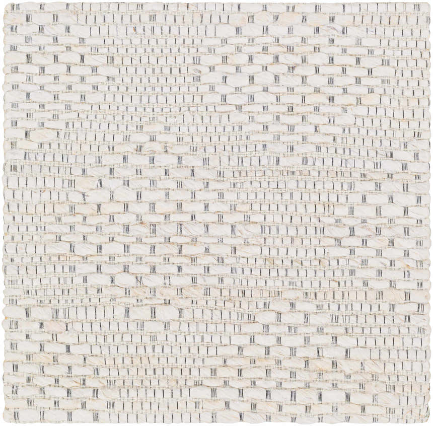 Close-up of the Angaston Beige Hand-Woven Jute Rug. Features a textured, woven design with beige and black accents. Swatch