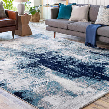 Living room scene with gray sofa and Apas Abstract Blue Area Rug. Modern, stylish interior. Roomscene-Rectangle