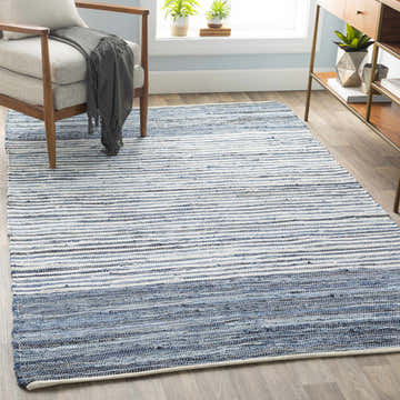 Living room scene with blue and white striped Armona Area Rug, gray chair, and wood console table. Roomscene-Rectangle