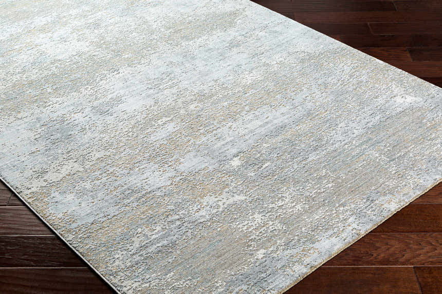 Close-up of the Avani Thick Luxe Boutique Rug showing its gray, light gray, and nutmeg abstract pattern. Corner