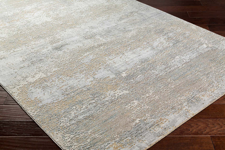 Close-up of the Avani Thick Luxe Boutique Rug, showcasing its gray, nutmeg, and white contemporary design and textured weave. Corner