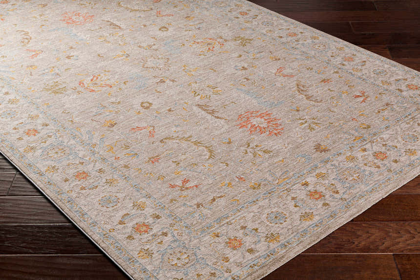 Close-up of the Awena Thick Luxe Area Rug, a traditional style rug with amber, brown, pink, and gray floral patterns. Corner