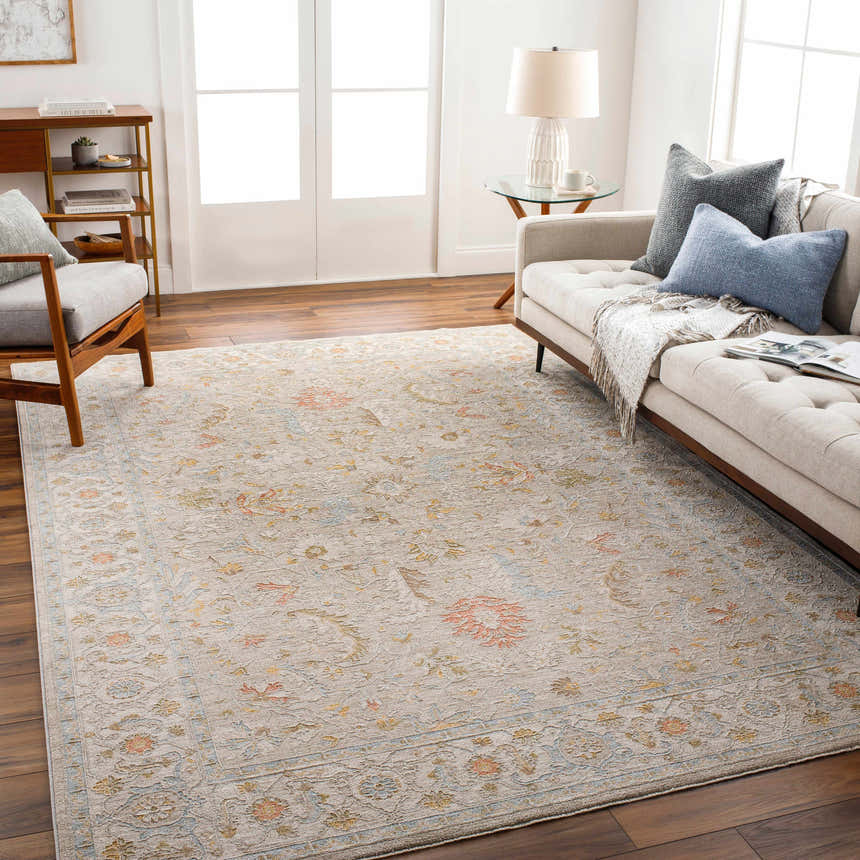 Living room with a beige sofa and the Awena Thick Luxe Area Rug in amber, pink, and gray floral pattern. Roomscene-Rectangle