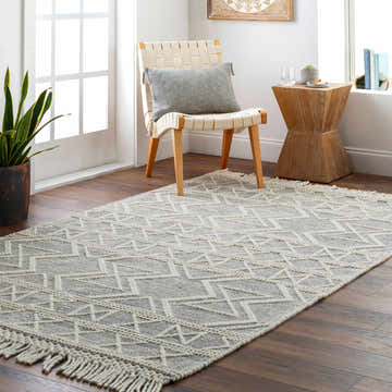 Bright entryway with a geometric Aziel Wool Rug. Bone and gray runner with tassels, chair, and wood accents. Roomscene-Rectangle