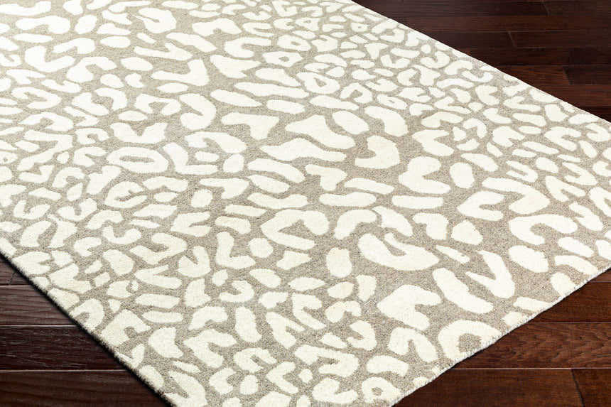 Close-up of the Azuka Leopard Print Area Rug, showing beige and gray animal print pattern and wool texture. Corner