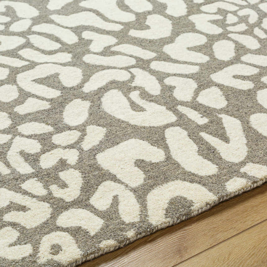 Close-up of the beige and gray Azuka Leopard Print Area Rug, a hand-tufted wool rug with a contemporary animal print design. Texture