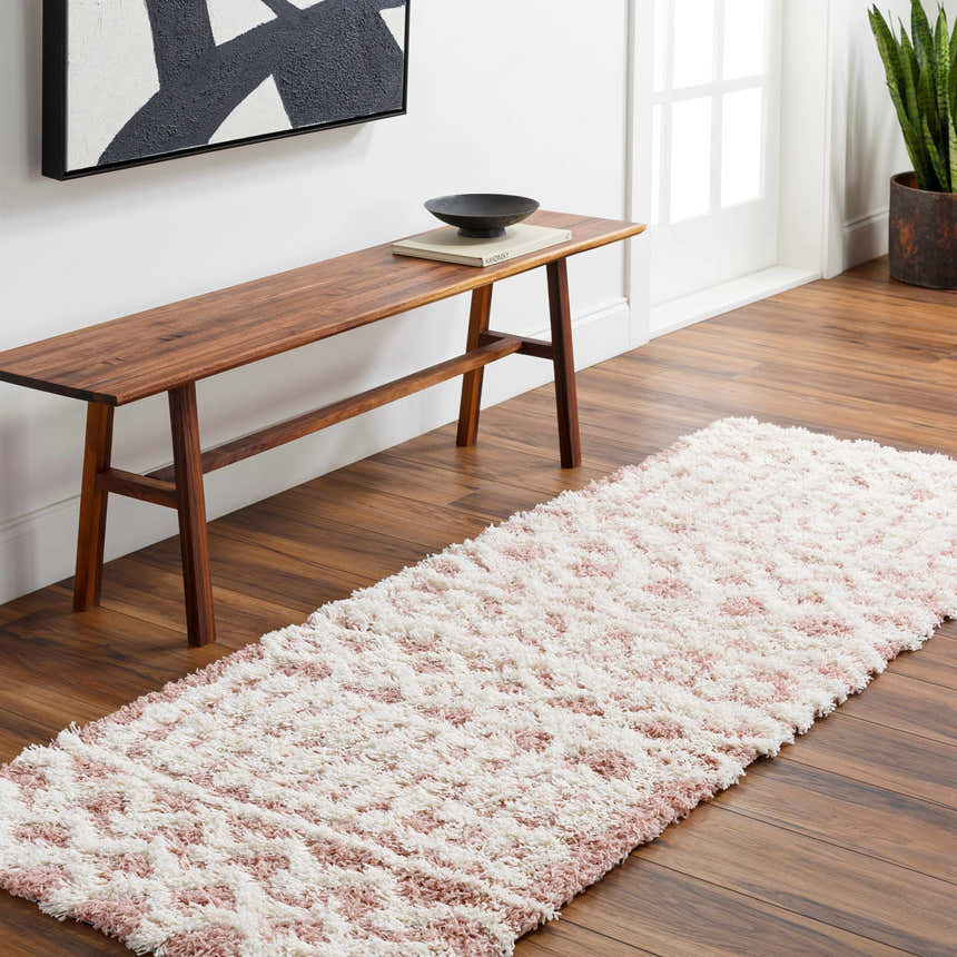 Hallway scene with a pink and white Azura Shag Area Rug runner, wood floors, and a wood bench with art above. Roomscene-Runner