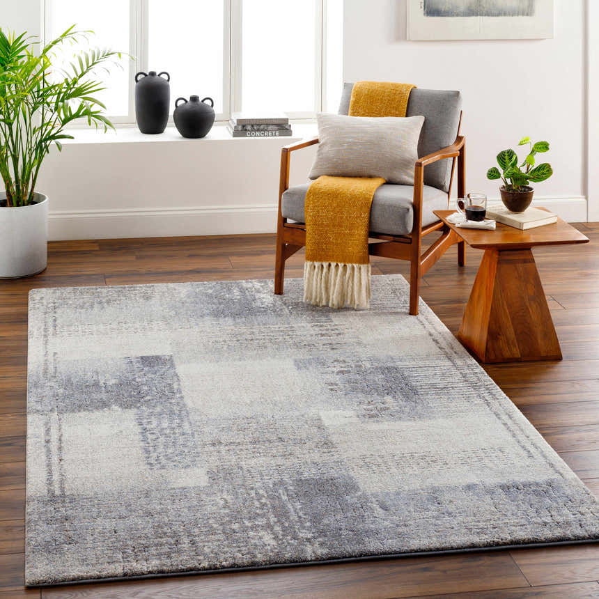Living room scene with gray chair, wood side table, and gray Bacca Area Rug. Roomscene-Rectangle