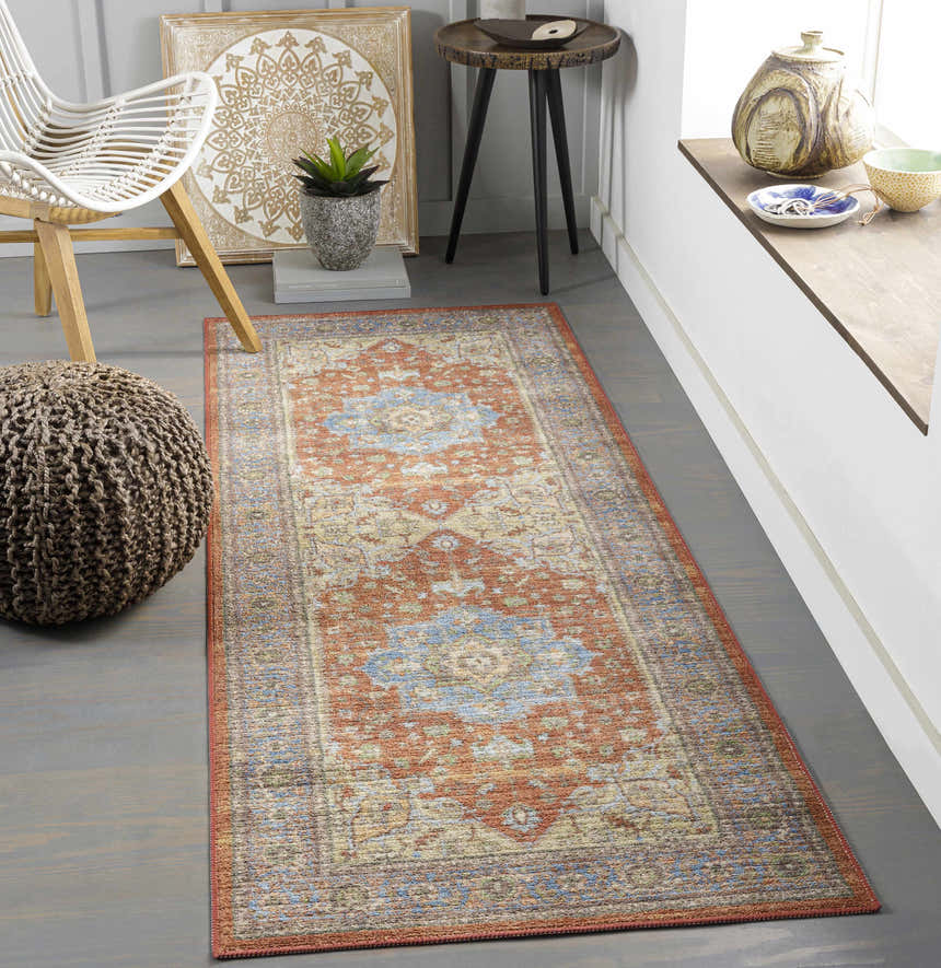 Bohemian entryway with Bacoor Washable Area Rug in brick red, beige, and blue. Features a white chair and woven pouf. Roomscene-Runner