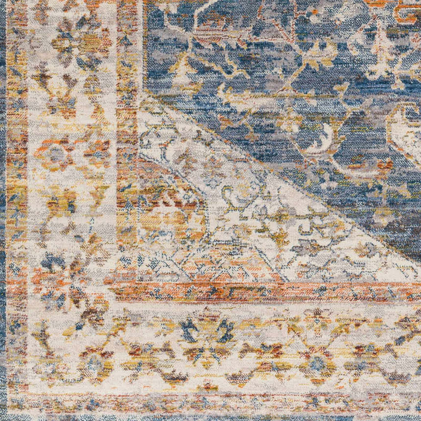 Close-up of the Solana Distressed Medallion Area Carpet, featuring brick red, burnt orange, and dark blue floral patterns. Swatch