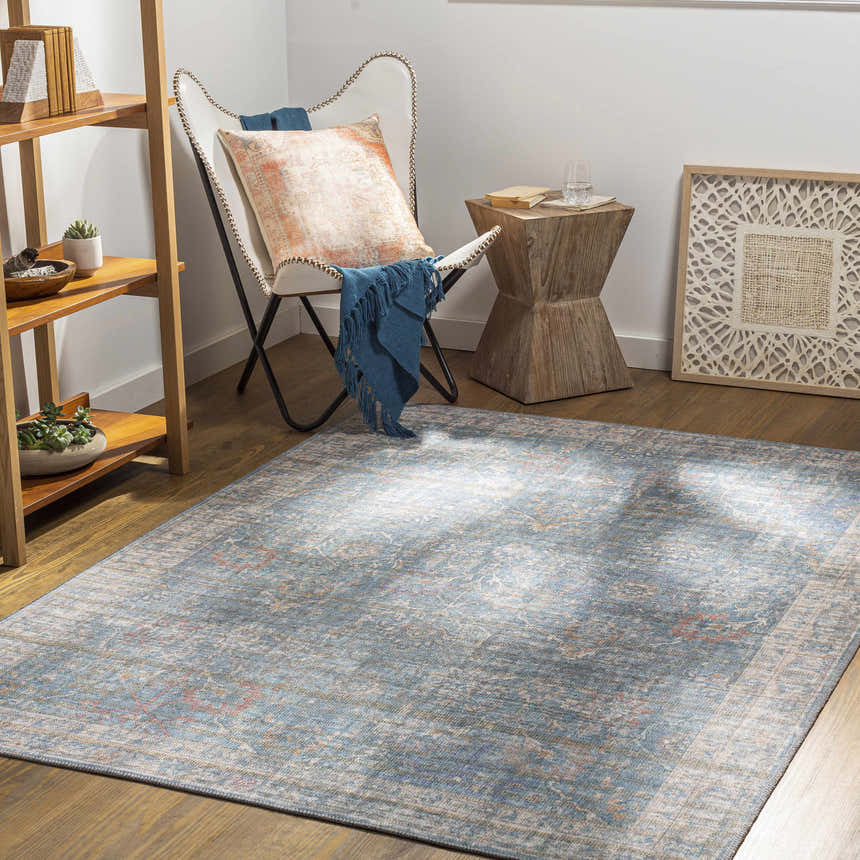 Coastal room scene with a blue and cream Bagontapay Washable Area Rug, butterfly chair, wood side table, and open shelving. Roomscene-Rectangle