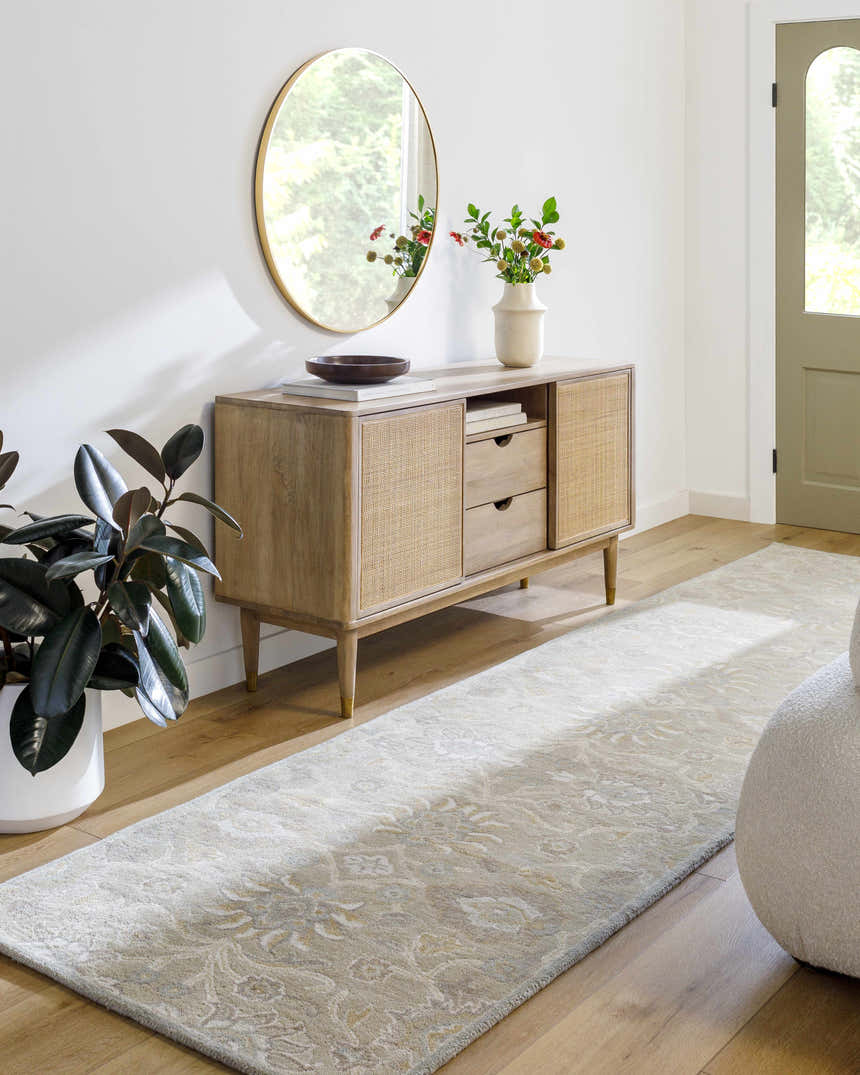Entryway with a Conesus Ivory & Taupe Wool Rug, wood floors, console table, mirror, and potted plant. Roomscene-Runner