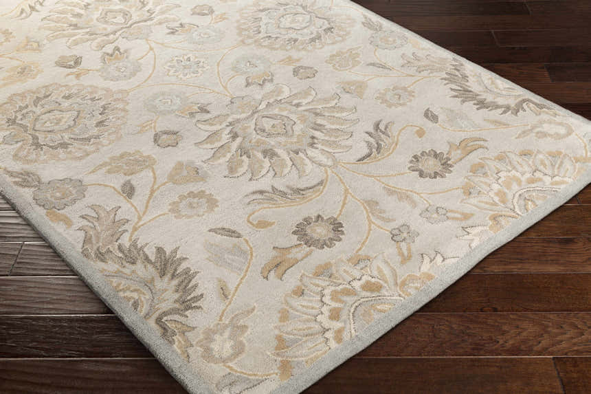 Close-up of the Conesus 1192 rug. Hand-tufted wool rug in ivory and taupe with a traditional floral pattern. Corner