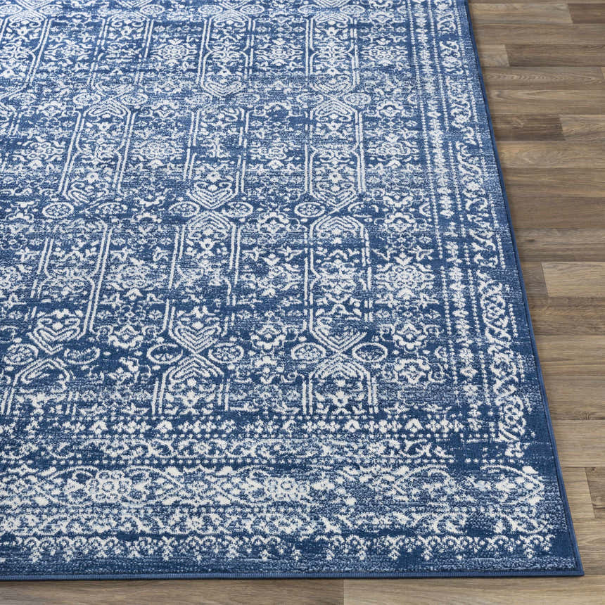 Close-up of the Michie Dark Blue Area Rug showing its intricate white, light blue, and dark blue bohemian pattern. Front