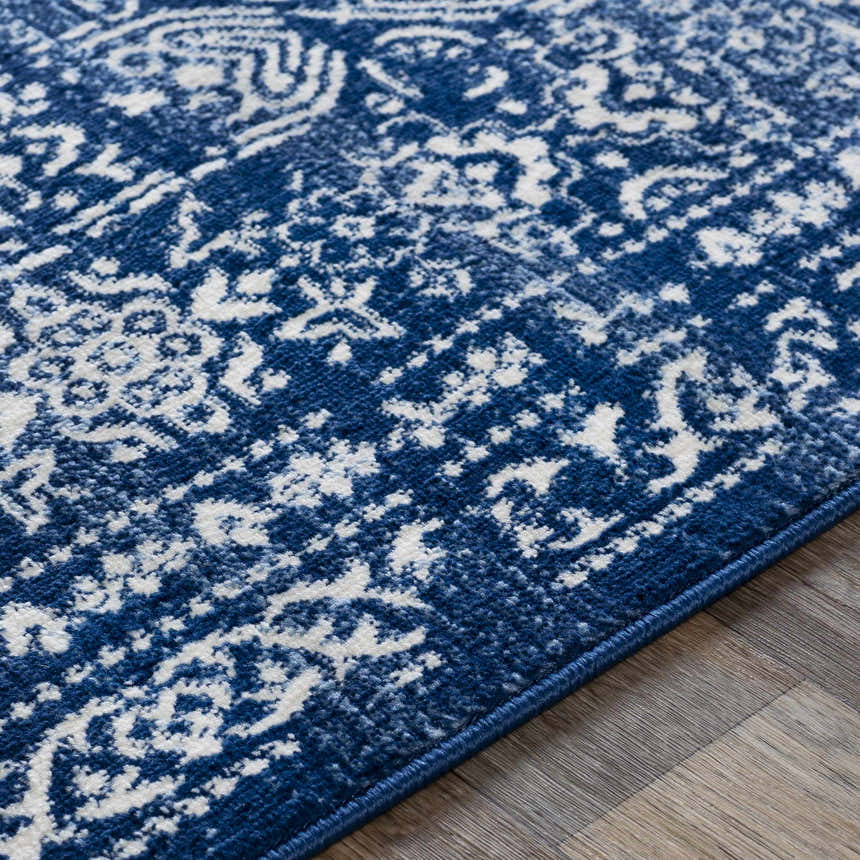 Close-up of the Michie Dark Blue Area Rug showing its bohemian white pattern and textured, machine-woven construction. Texture