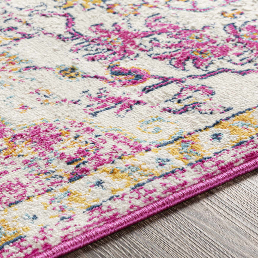 Close-up of Barceloneta Magenta Area Rug showing its fuchsia, light blue, and mustard bohemian-style pattern. Texture