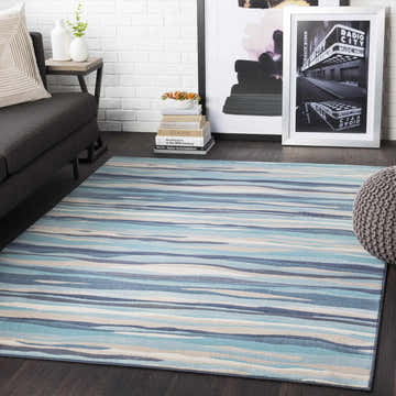 Living room scene with blue striped Basco Area Rug, gray sofa, and modern decor. Roomscene-Rectangle
