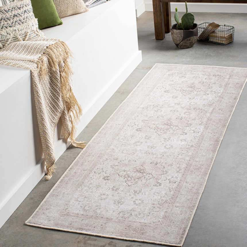 Entryway with beige Bethany Vintage Flat Pile Washable Rug, concrete floor, white bench with throw and pillows. Roomscene-Runner