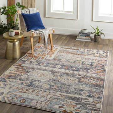 Living room scene with a Blackmoor Aztec Area Rug, chair, side table, and plants. Southwestern style. Roomscene-Rectangle