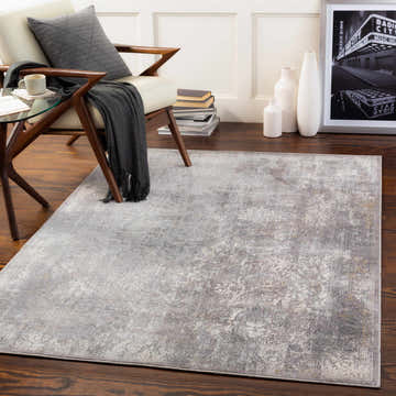 Living room scene with a charcoal and cream Blean Area Rug, chair, and modern decor. Roomscene-Rectangle