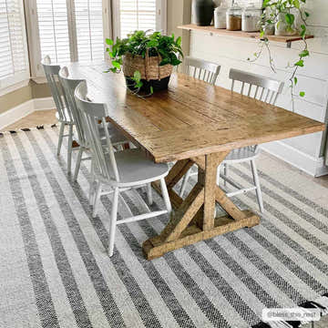 Dining room with a rustic wood table on a black and cream striped Contrecoeur Area Carpet. Roomscene-Rectangle