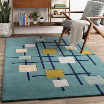 Living room scene with a Bellvue Modern Hand Tufted Wool Rug in dark blue, beige, gray, and mustard tones. Mid-century modern style. Roomscene-Rectangle