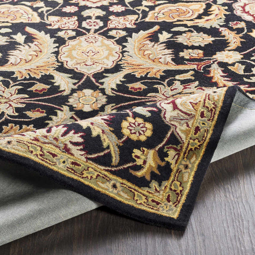 Close-up of the Blomkest Black&Yellow Traditional Wool Carpet showing its floral Persian-style design and hand-tufted texture. Fold