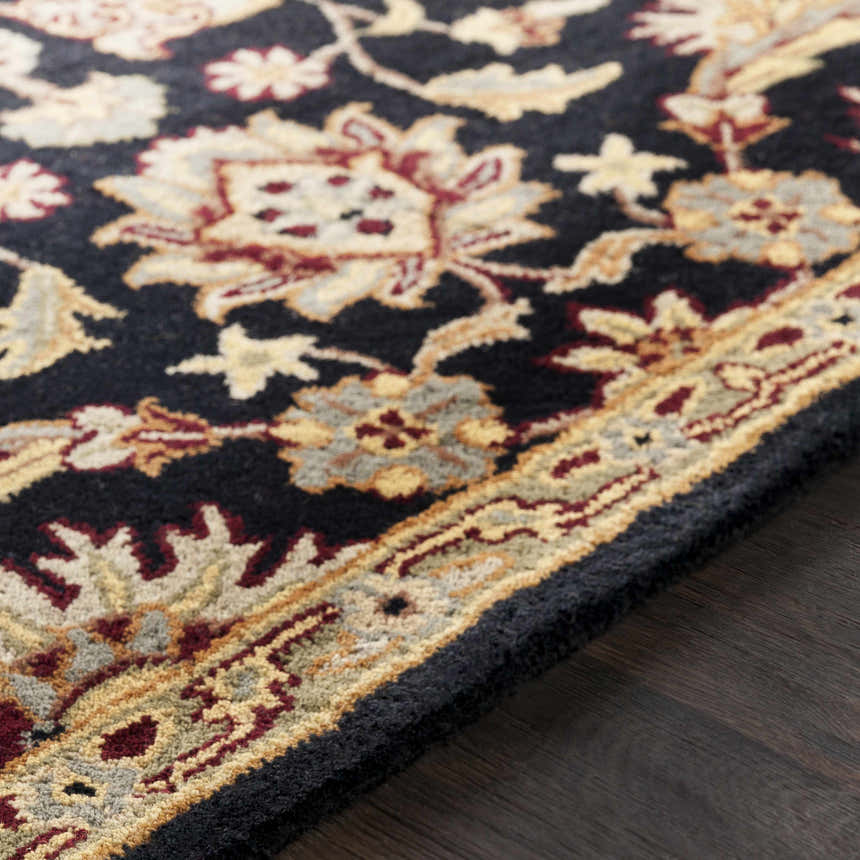 Close-up of the Blomkest Black&Yellow Traditional Wool Carpet featuring floral and geometric patterns in beige, burgundy, and black. Texture