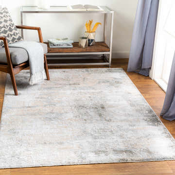 Living room scene with a Bennet Thick Luxe Boutique Rug in light gray, charcoal, and taupe. Roomscene-Rectangle