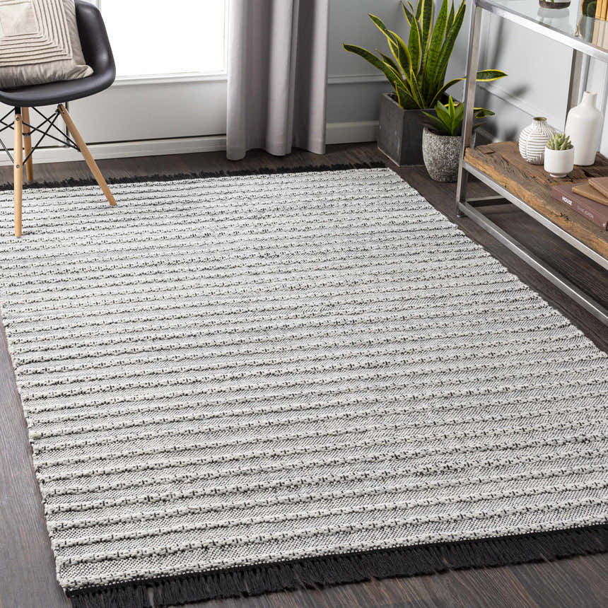 Living room scene with black chair and gray Brockman Area Rug with horizontal stripes. Roomscene-Rectangle