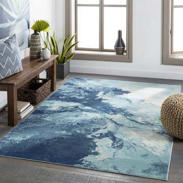 Bright Sky Indoor/Outdoor Rug in a sunlit living room with a wooden bench, woven pouf, and coastal decor. Roomscene-Rectangle