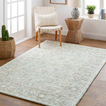 Light and airy mudroom scene with a Browning Wool & Faux Silk Rug in aqua, beige, and light gray. Woven chair and wood side table. Roomscene-Rectangle