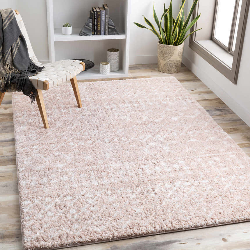 Light and airy room scene with a blush and cream Plush Area Rug, chair, bookshelf, and wood floors. Roomscene-Rectangle
