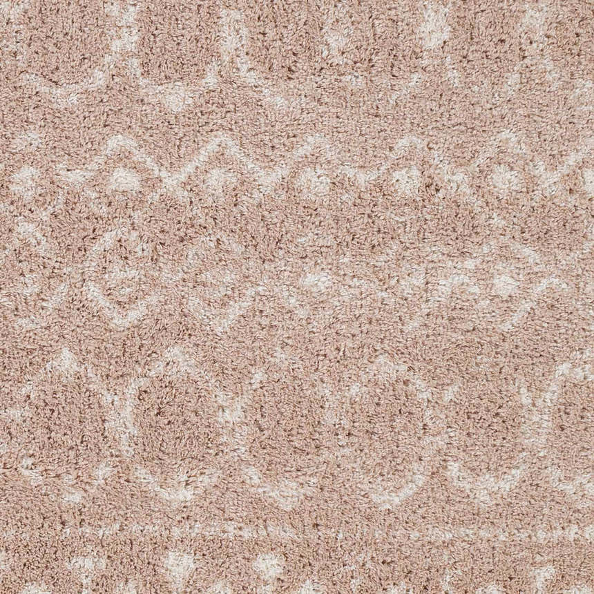 Close-up of the Blush Plush Area Rug, showing its plush texture and subtle cream geometric pattern on a blush background. Swatch