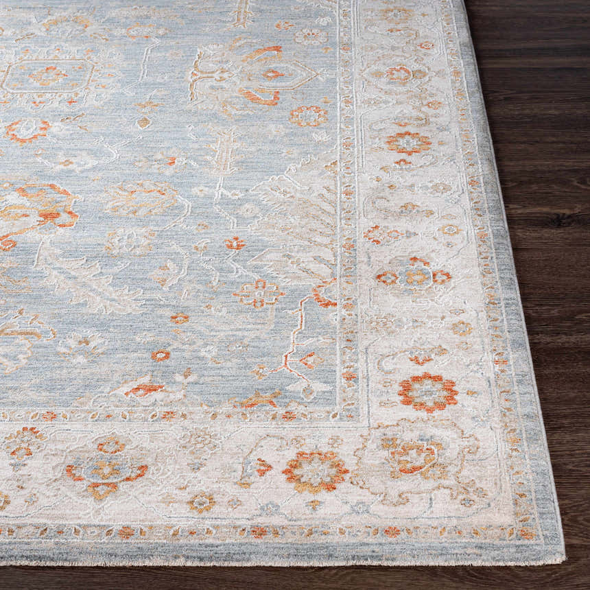 Close-up of the Camrose Thick Luxe Statement Rug, showing its light blue, beige, and orange traditional floral pattern. Front
