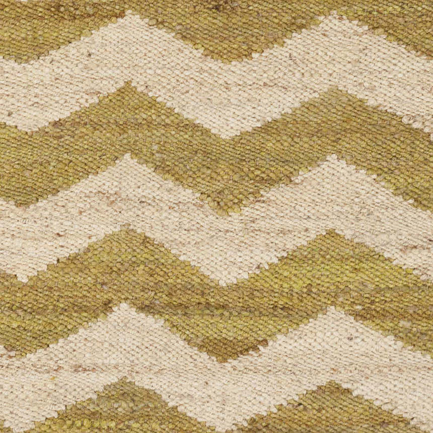 Close-up of the Cardigan Jute Carpet, a hand-woven rug with a beige and lime green chevron pattern. Natural fiber texture. Swatch