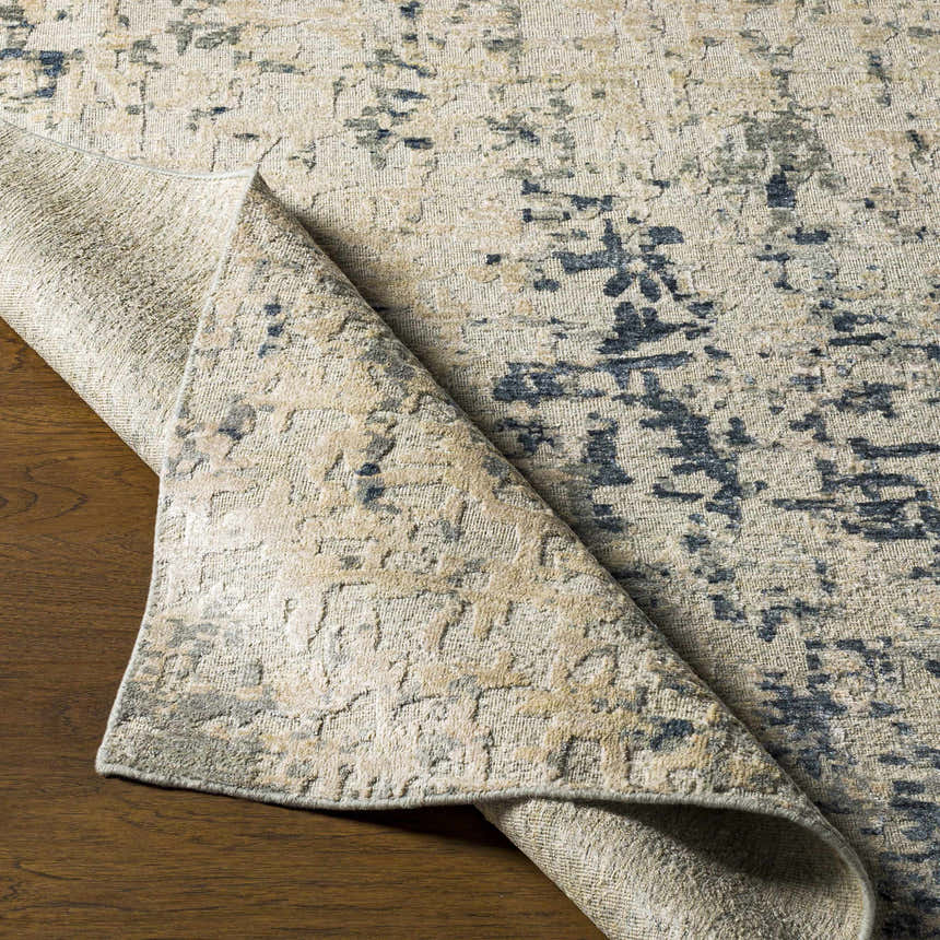 Close-up of the hand-knotted Cayuga Area Rug, showcasing its dark blue, sage, and off-white contemporary design and silk texture. Front