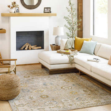 Living room with a cream sectional and the Cabinteely Luxe Oushak Rug in cream, denim, and light brown. Roomscene-Rectangle