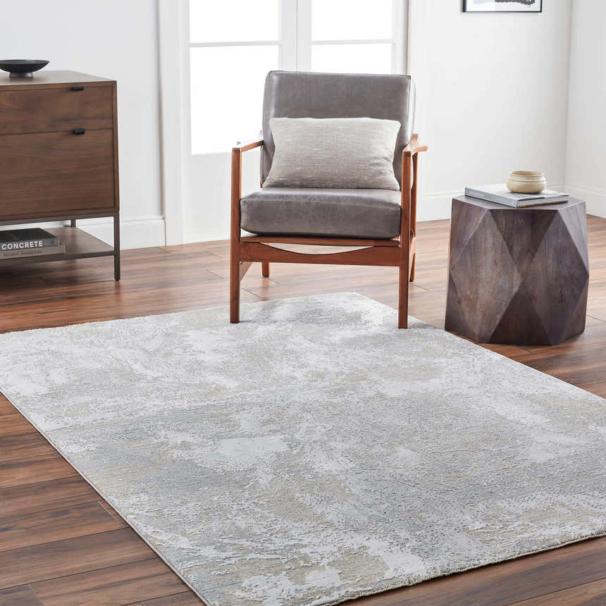 Living room scene with a gray Cady Thick Luxe Area Rug, wood floors, gray chair, and wood accent furniture. Roomscene-Rectangle