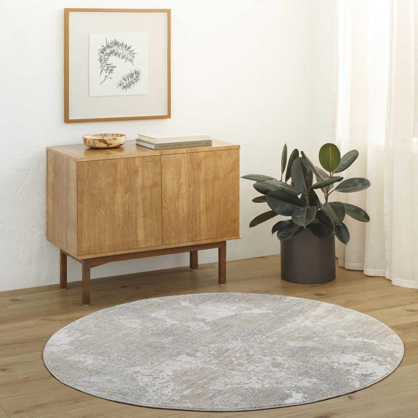 Living room scene with a round Cady Thick Luxe Area Rug in cloud gray and light gray. Roomscene-Round