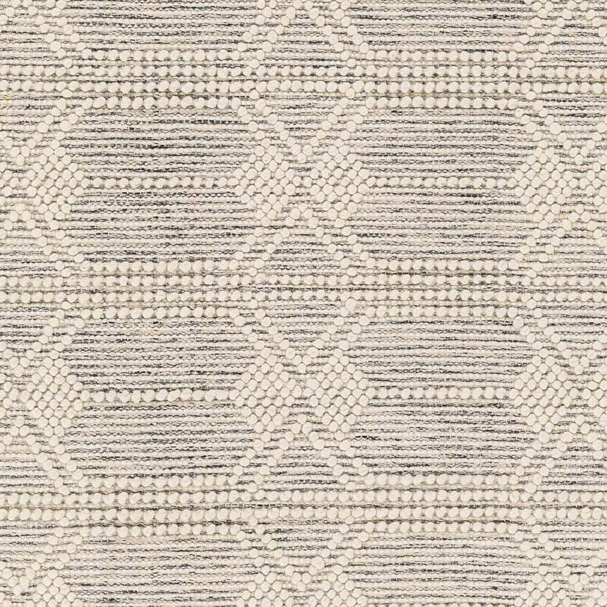 Close-up of the Chars Wool Rug. Bone and gray rug with a geometric pattern and textured, hand-woven construction. Swatch